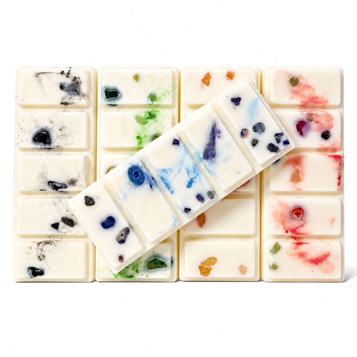 Collection of beautiful crystal infused wax melts with vibrant colors and embedded gemstones.