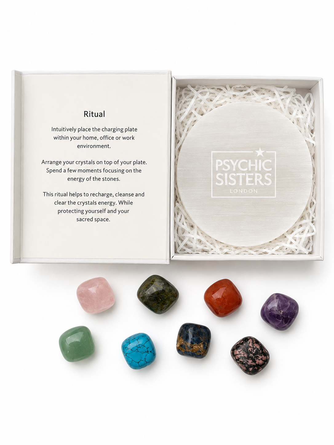 Selenite charging plate from Psychic Sisters with an array of colorful gemstones for energy cleansing.