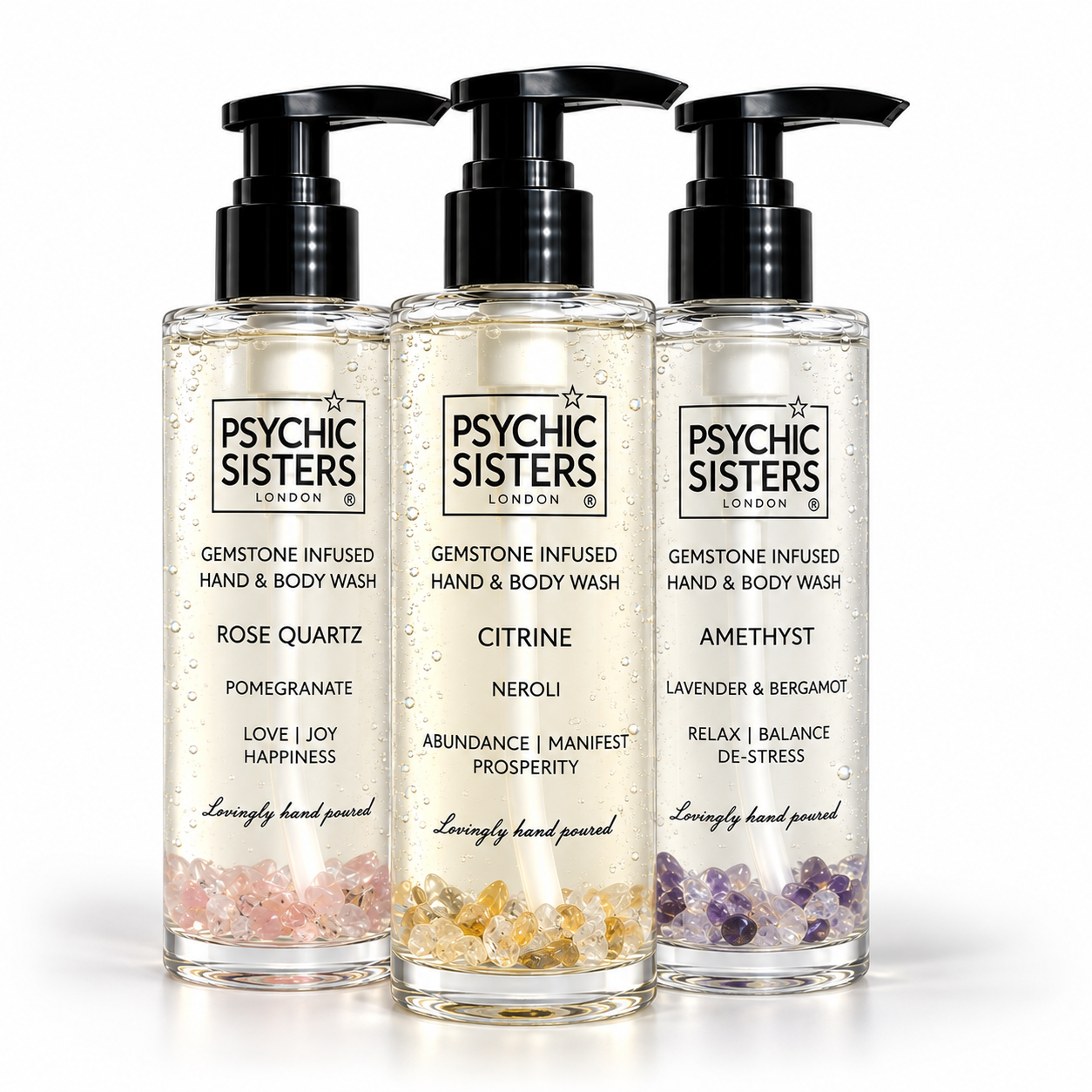 Three bottles of gemstone-infused bath products: hand & body wash featuring rose quartz, amethyst, and citrine.