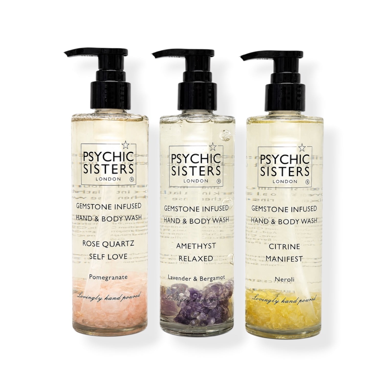 Three bottles of gemstone-infused bath products: hand & body wash featuring rose quartz, amethyst, and citrine.