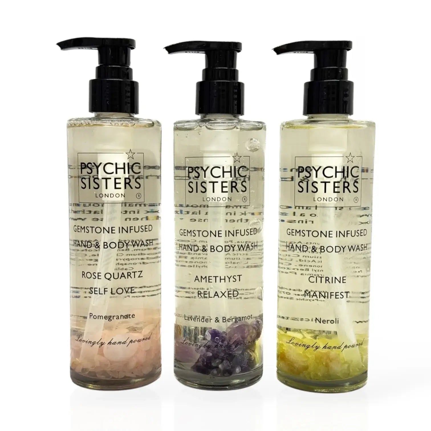 Three bottles of gemstone-infused bath products: hand & body wash featuring rose quartz, amethyst, and citrine.