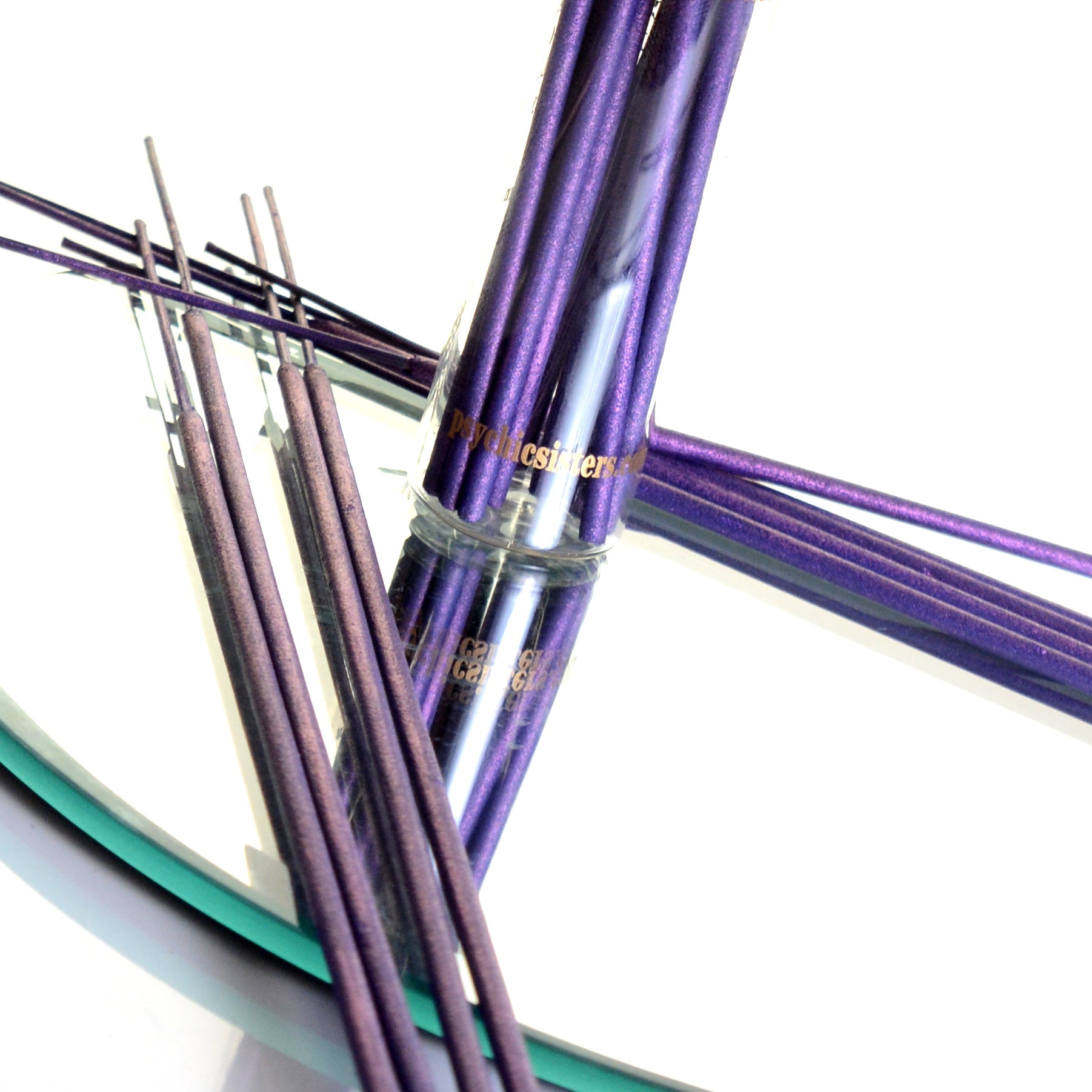 Mixed Incense sticks in purple packaging, handmade and reusable, on a reflective surface.