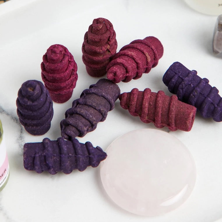 Colorful aromatic cones from the Love Ritual Set featuring rose and lavender scents.