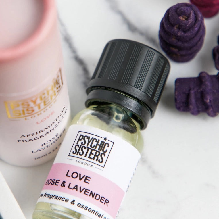 Love Ritual Set featuring Psychic Sisters rose and lavender essential oil bottle close-up