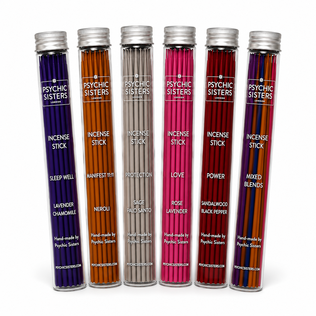 Five clear cylindrical tubes of Psychic Sisters brand incense sticks on a white background, each filled with different colored sticks and labeled with scent names such as Sleep Well, Manifest Truth, Love, Power, and Mixed Blends.