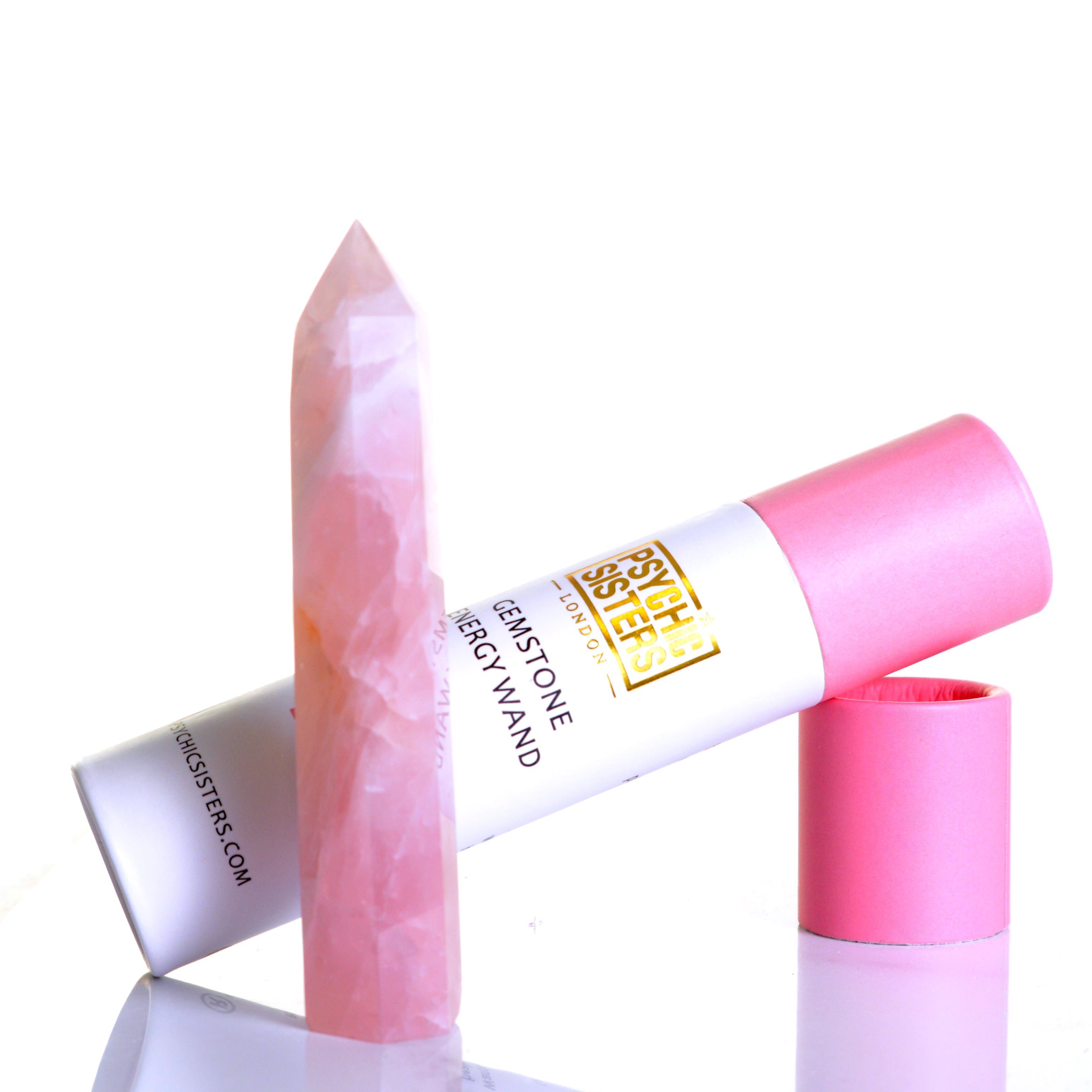 Rose Quartz Point crystal standing next to a pink cardboard tube for energy wand, showcasing its natural beauty.