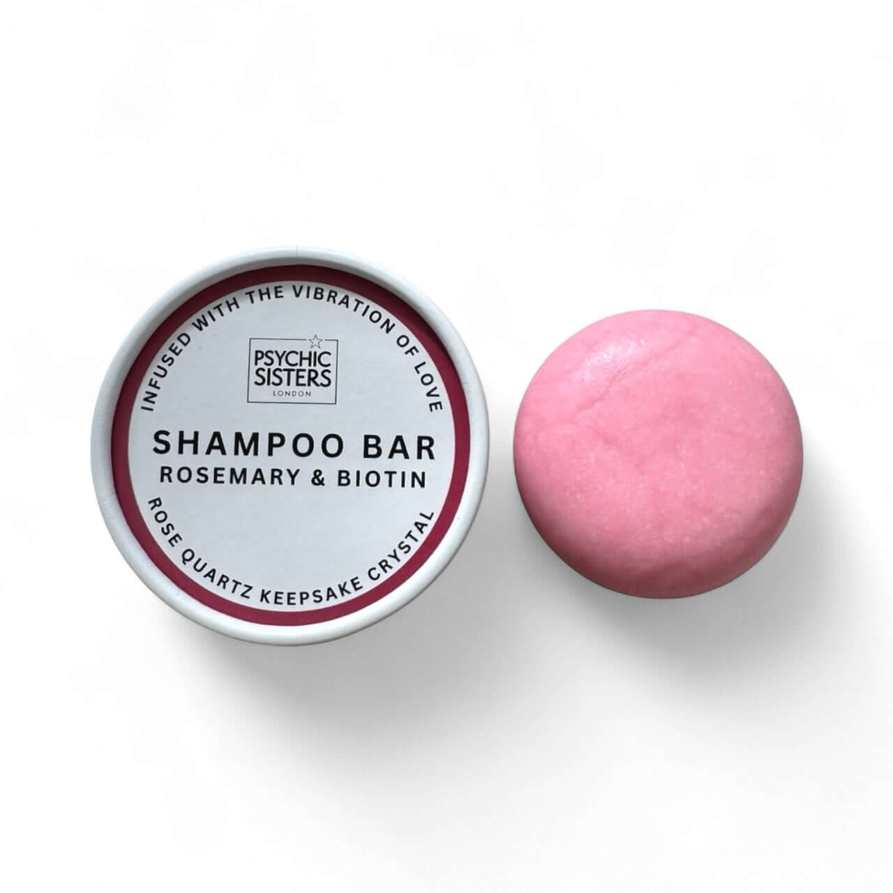 Rosemary And Biotin Shampoo Bar with a pink solid shampoo and packaging by Psychic Sisters.