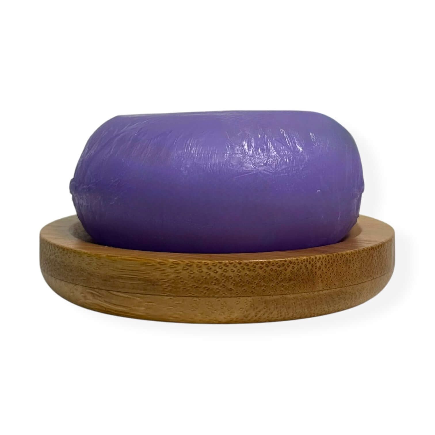 Rosemary biotin conditioner bar displayed on a wooden holder, showcasing its purple hue and eco-friendly design.