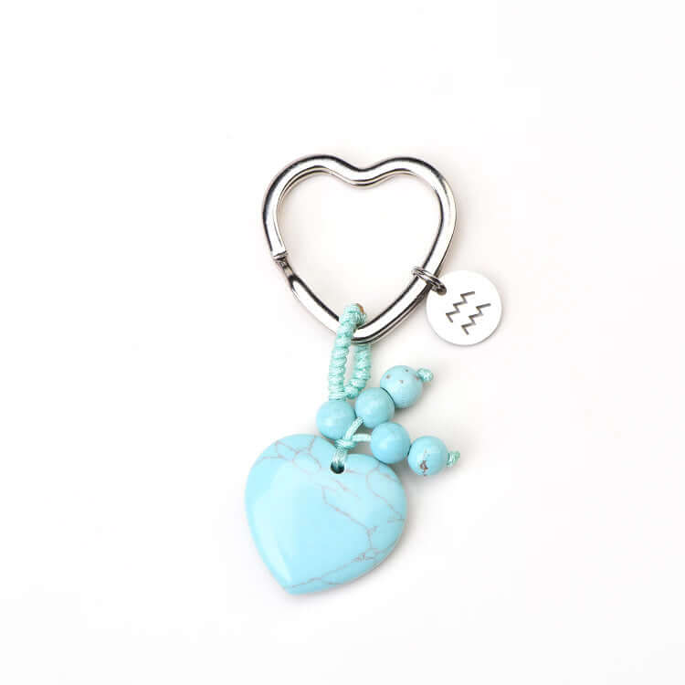 Heart-shaped keychain with turquoise stone and beads on a white background