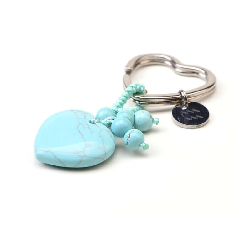 Turquoise keychain with heart-shaped charm and beads on a white background