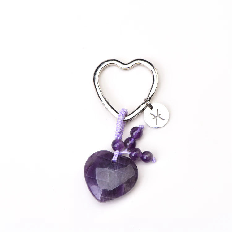 zodiac gemstone Heart-shaped keychain with purple amethyst stone and beaded chain on a white background