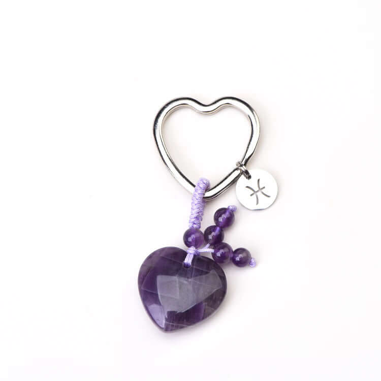 zodiac gemstone Heart-shaped keychain with purple amethyst stone and beaded chain on a white background