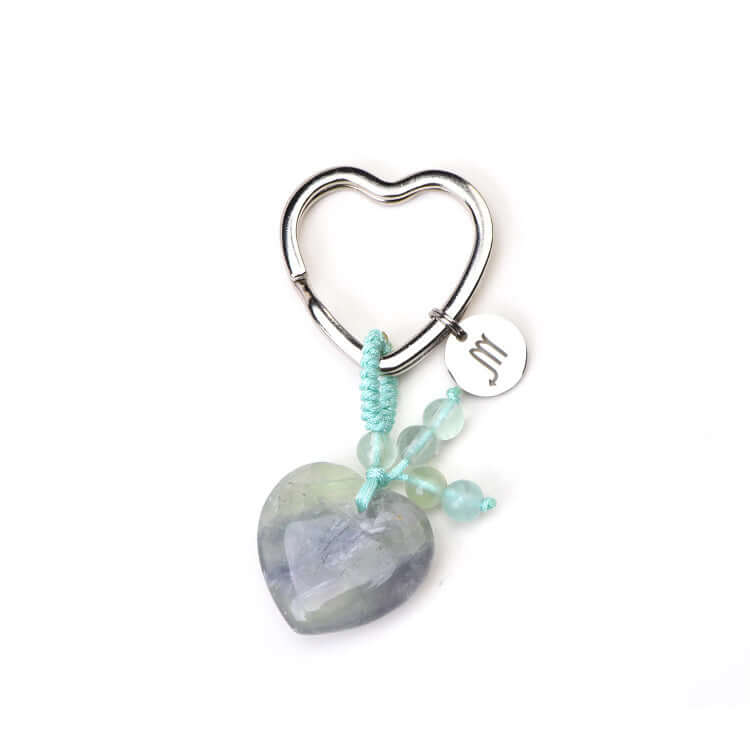 Psychic Sisters zodiac Heart-shaped keychain with a heart-shaped stone and turquoise beads on a white background