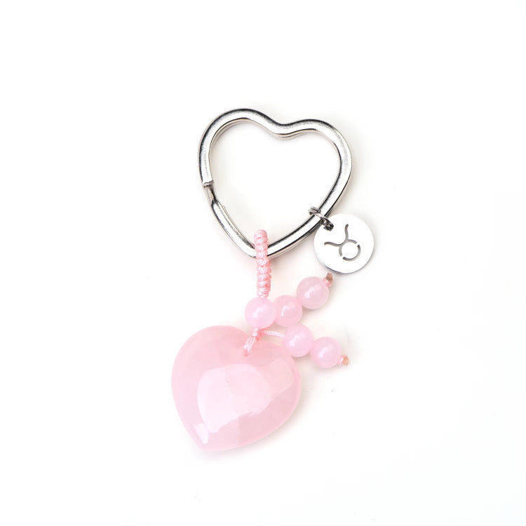 Psychic Sisters Zodiac Heart-shaped keychain with pink beads and a pink heart charm on a white background