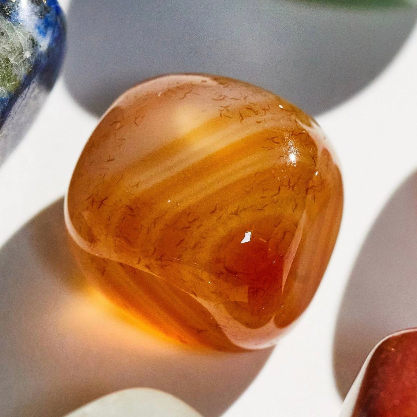 Aries Crystal Set (March 21 – April 19) featuring a natural orange crystal with unique patterns and textures.