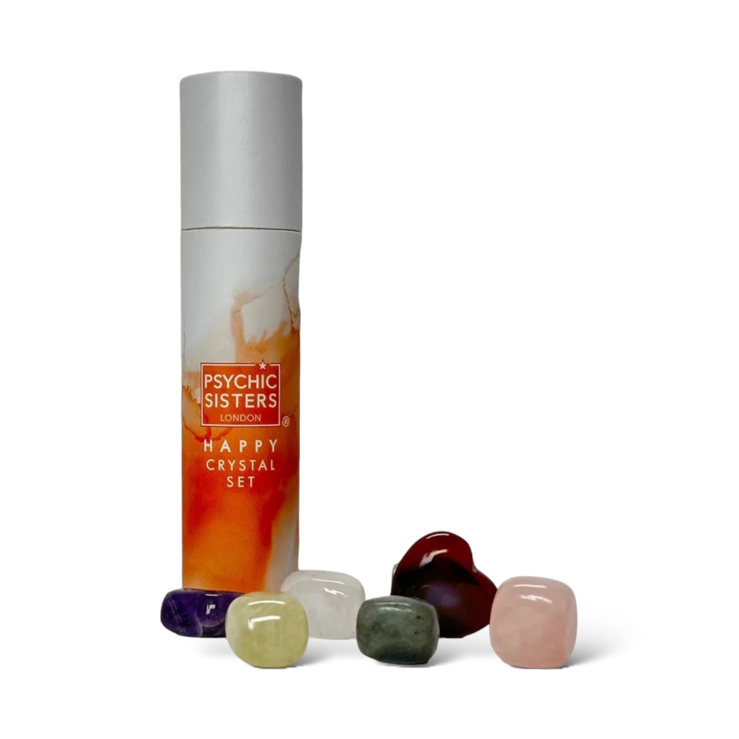A set of seven multicolored crystals in various sizes, displayed in front of a cylindrical cardboard package labeled 'Happy Crystal Set' by Psychic Sisters.