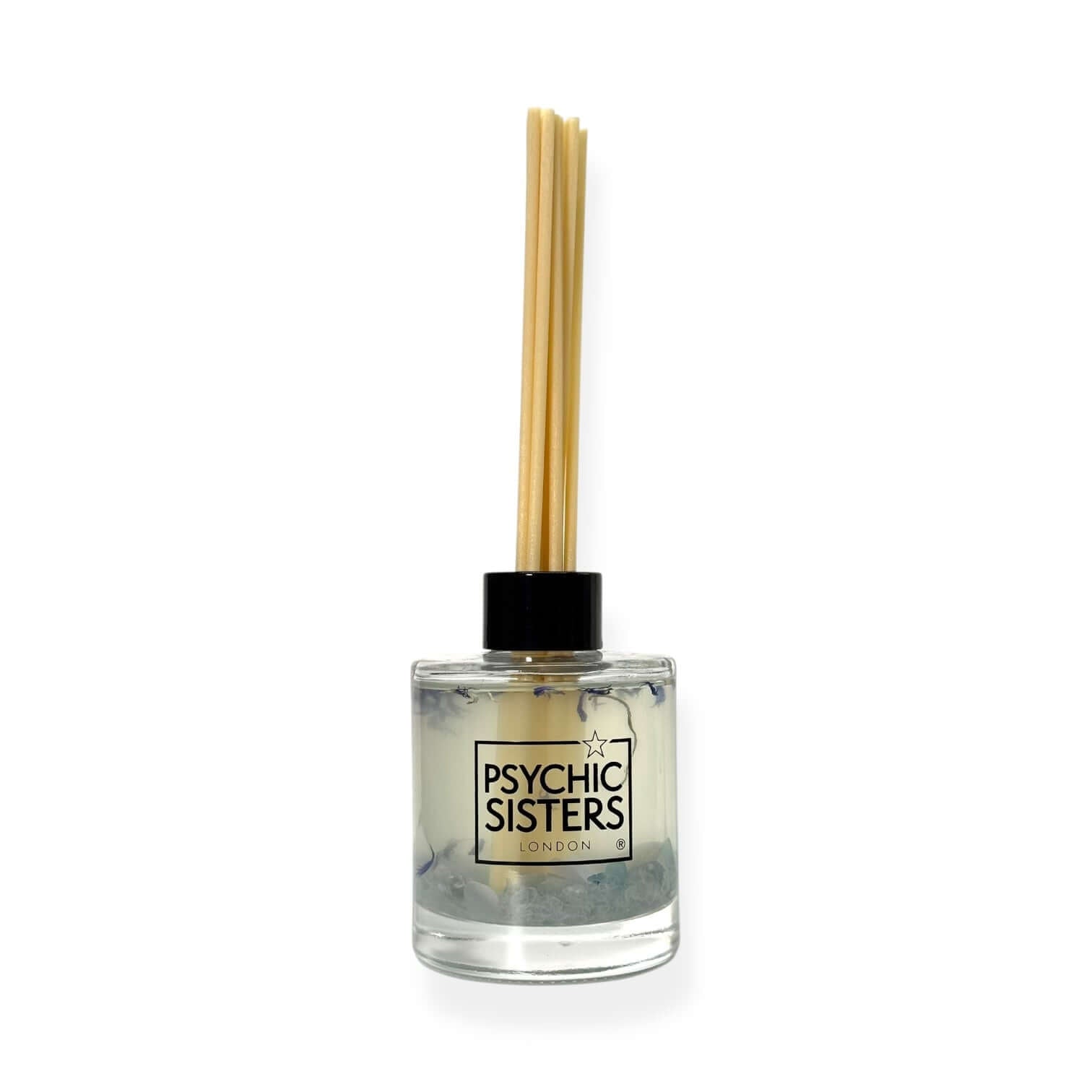 Reed diffuser with wooden sticks and clear bottle labeled 'Psychic Sisters' on a white background
