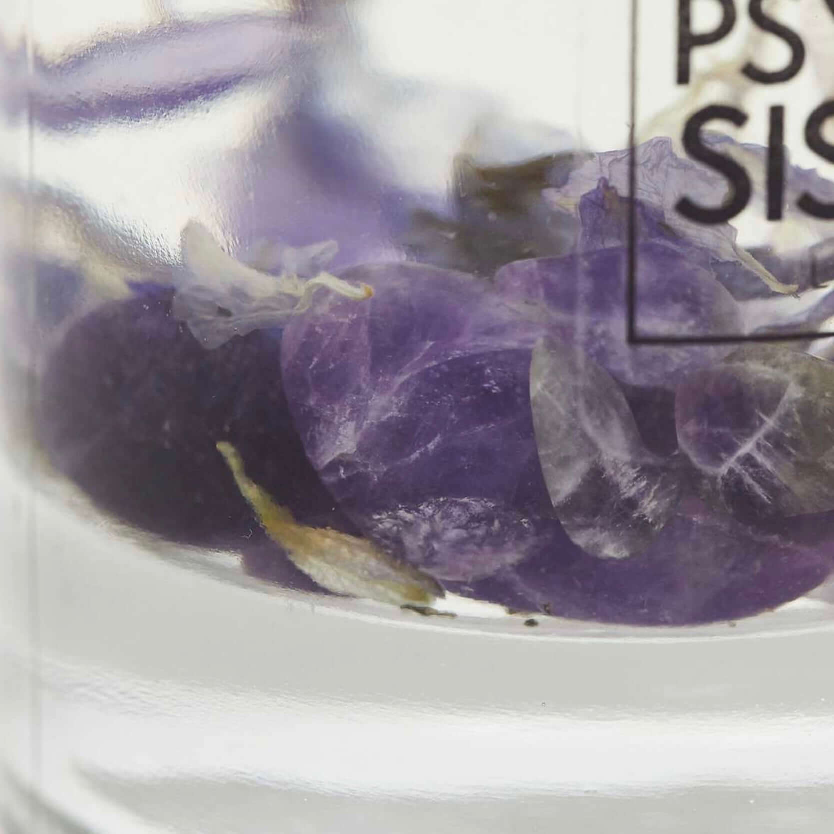 Close-up of amethyst crystals in a reed diffuser showcasing natural relaxation and luxury home decor.
