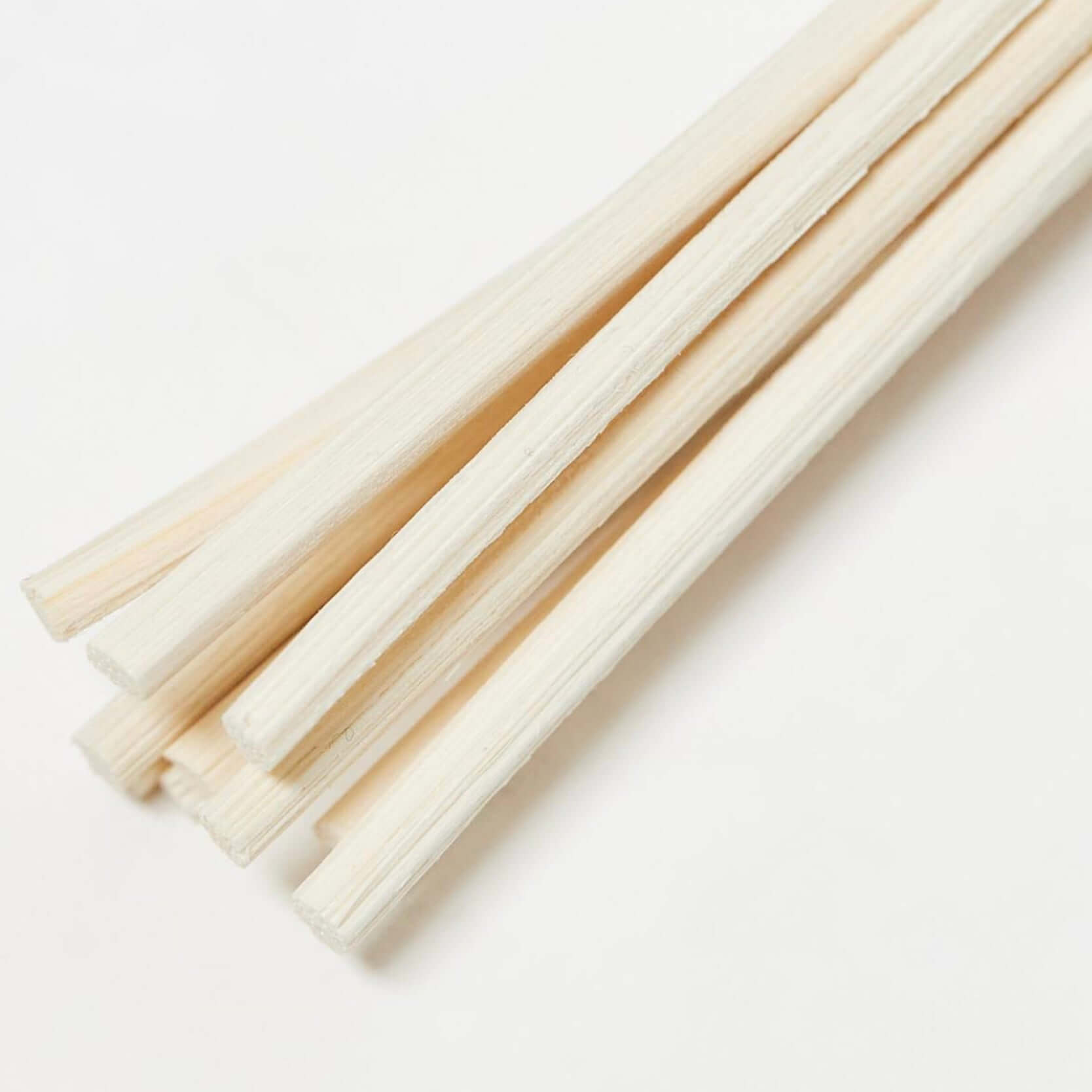 A close-up of natural reed sticks for use in a reed diffuser.