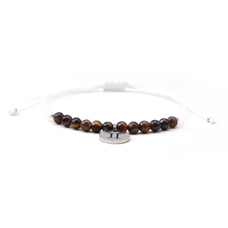 Psychic Sisters Gemini zodiac bracelet featuring brown tiger eye crystal beads and a silver star sign charm.