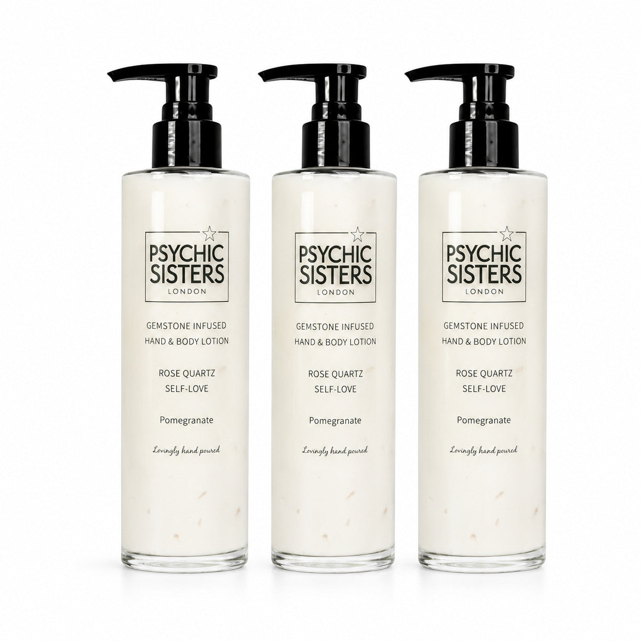 Psychic Sisters gemstone infused hand and body lotion in clear recycled glass bottles with black pump dispensers.