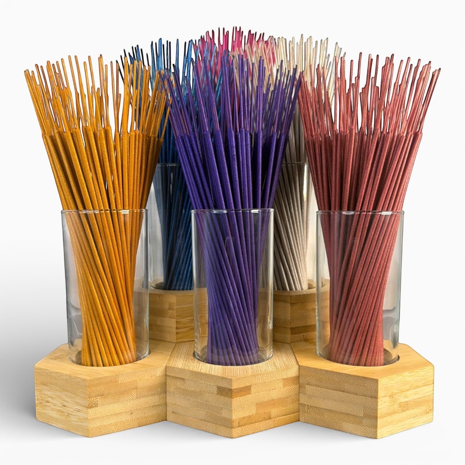 Psychic Sisters hexagonal bamboo and glass incense holders arranged in a honeycomb cluster filled with colorful sticks.