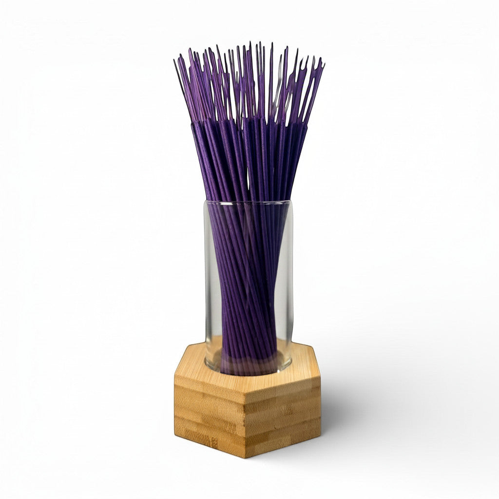 Psychic Sisters hexagonal bamboo and glass incense holder filled with purple incense sticks on a white background.