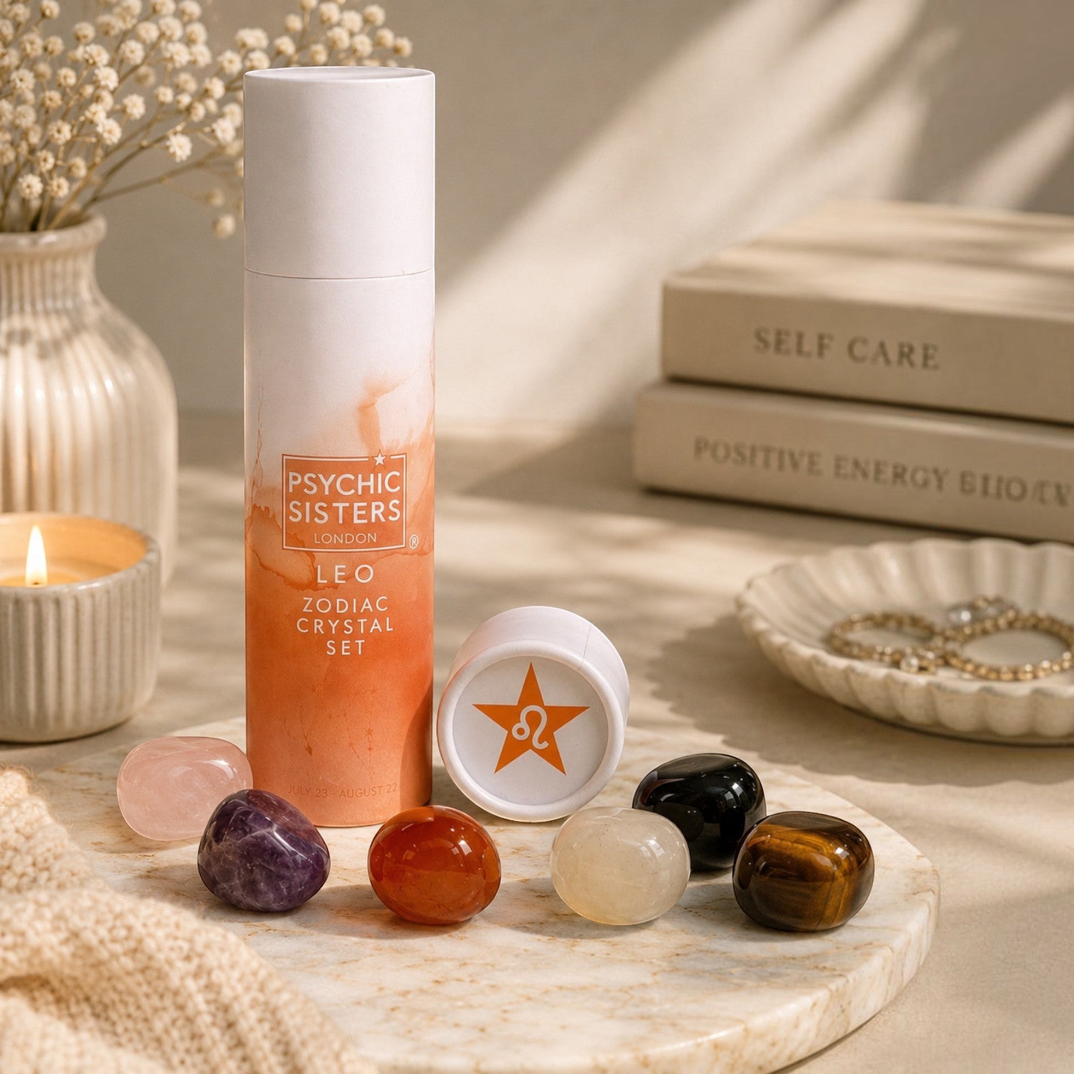 Psychic Sisters Leo Zodiac Crystal Set with six tumbled gemstones and affirmation card in a recycled cardboard tube.