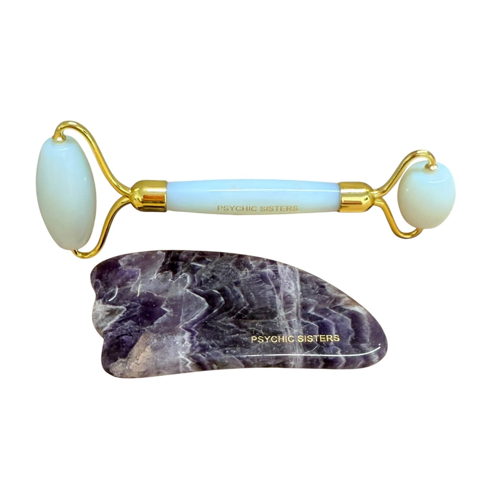 Psychic Sisters opalite dual-ended facial roller and purple amethyst gua sha skincare set on a white background