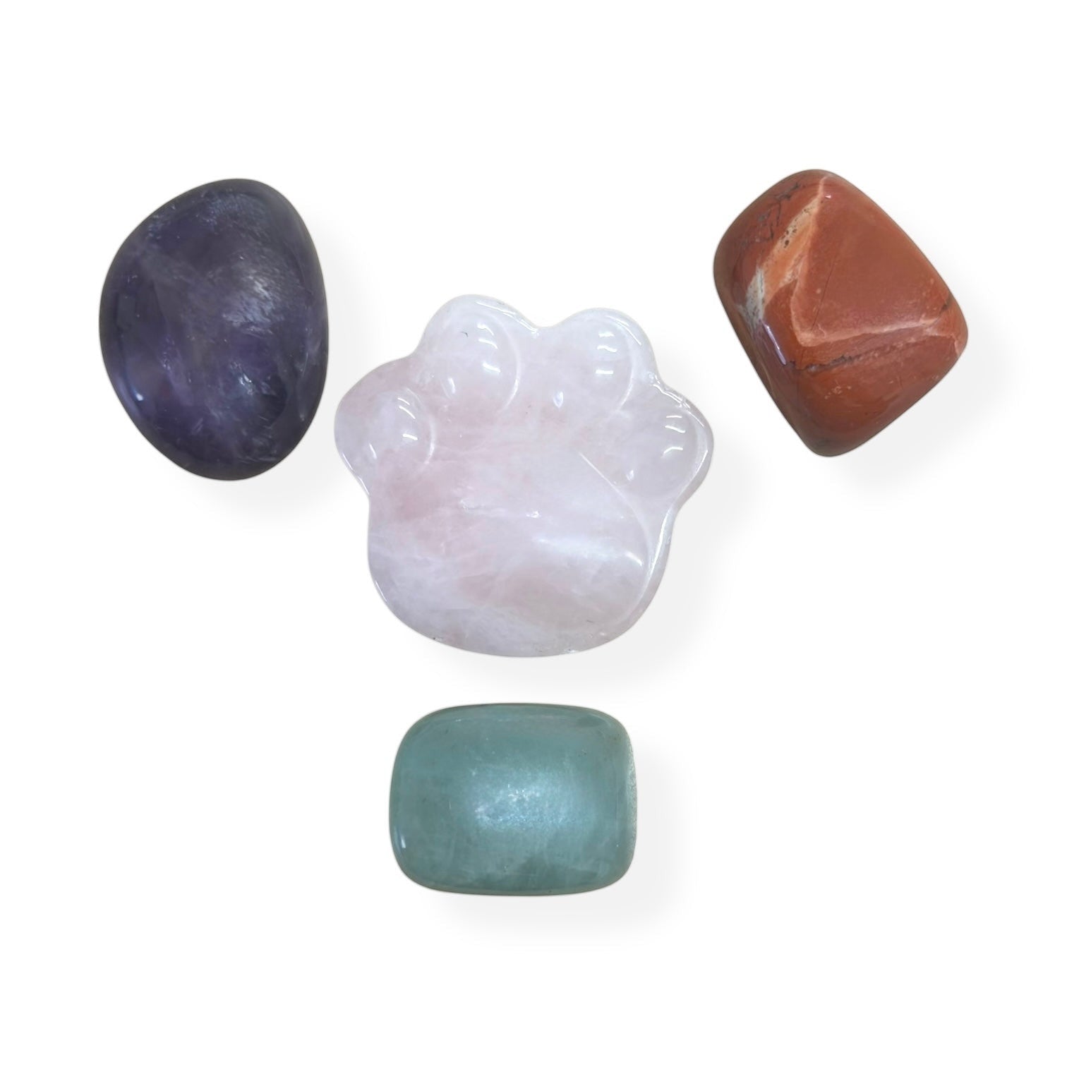 Psychic Sisters crystal healing set featuring a central rose quartz paw print stone with amethyst, jasper, and jade.