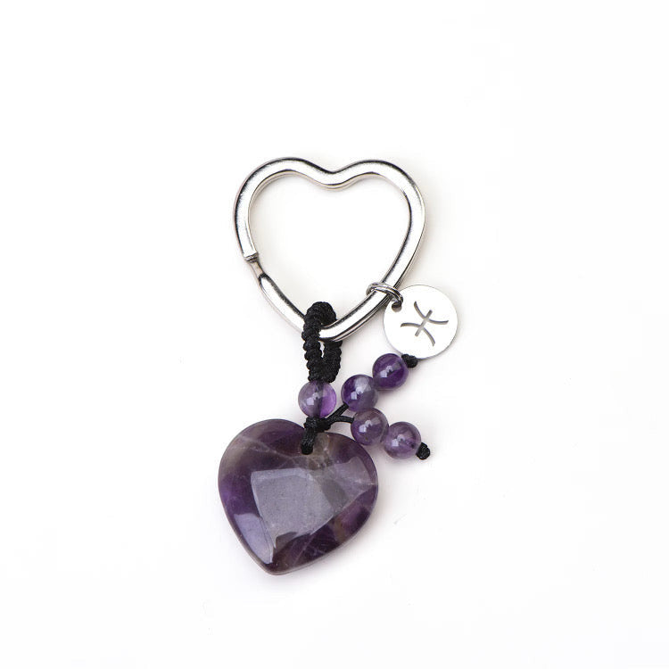 Psychic Sisters Pisces zodiac keyring featuring a purple heart-shaped crystal, small amethyst beads, and silver charm.