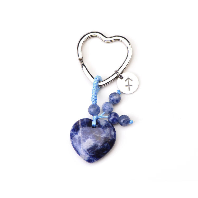 Psychic Sisters Sagittarius zodiac keyring with a blue heart-shaped crystal, silver symbol disk, and beaded charm.