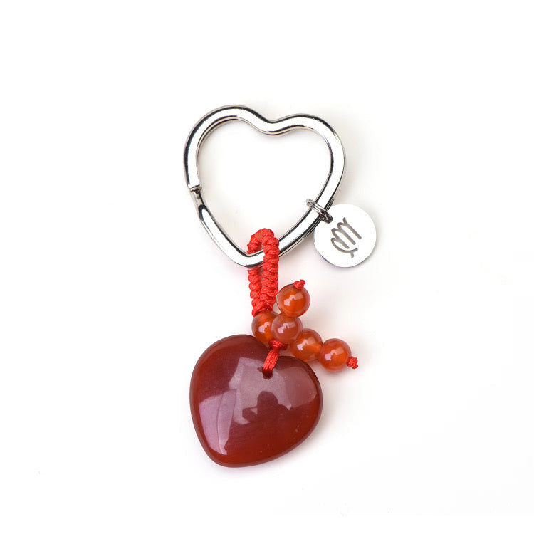 Psychic Sisters zodiac crystal keyring featuring a heart-shaped strawberry quartz, red cord, and silver zodiac charm.